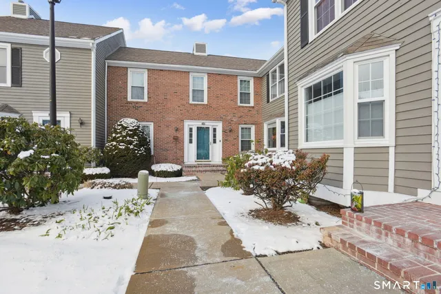a view of a house with a yard and sitting area