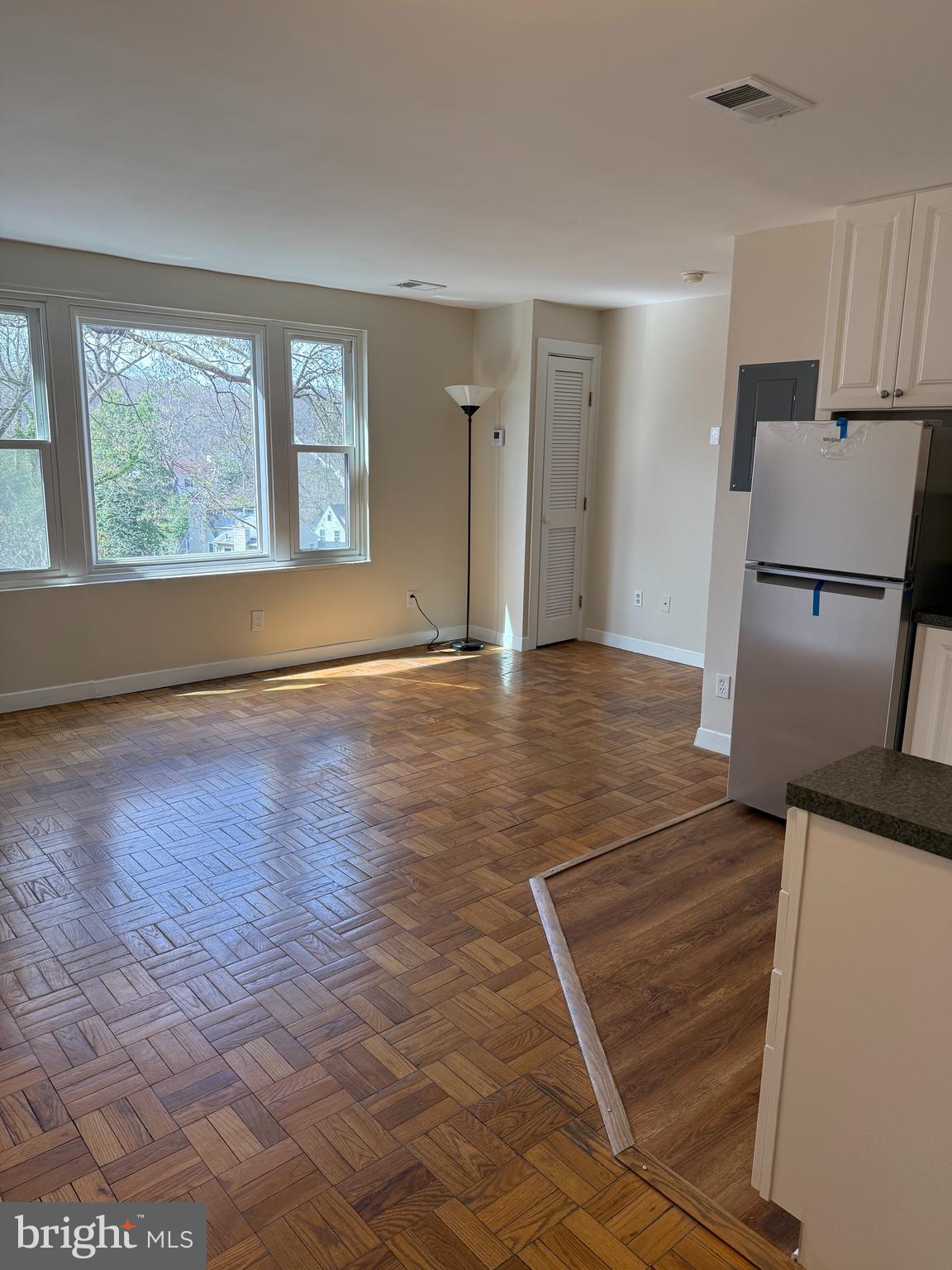 4840 MacArthur Boulevard Northwest, Unit 504 Washington, DC 20007 - Photo 5 of 10 wooden floor in an empty room with a window