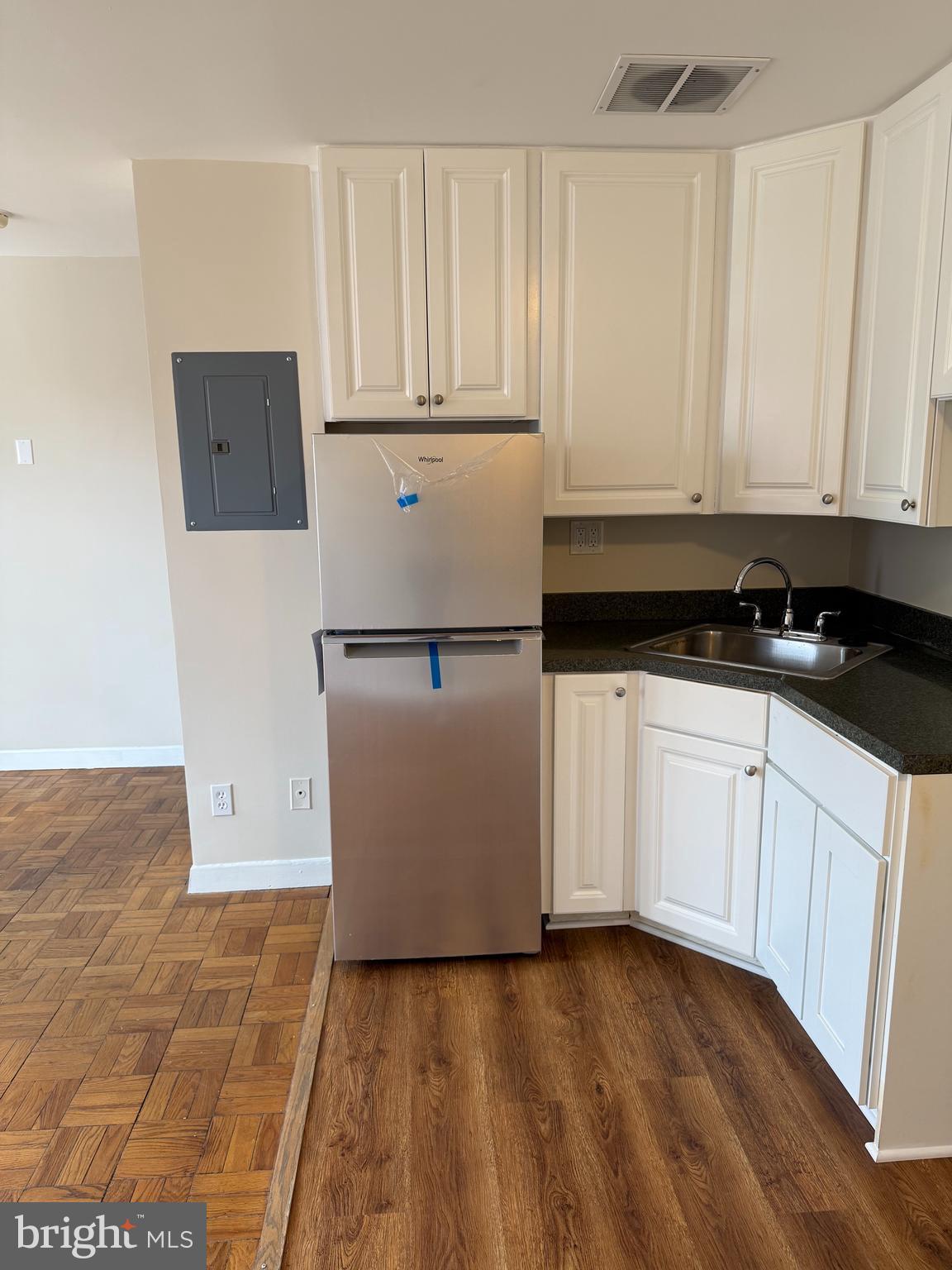 4840 MacArthur Boulevard Northwest, Unit 504 Washington, DC 20007 - Photo 7 of 10 a kitchen with white cabinets and white appliances