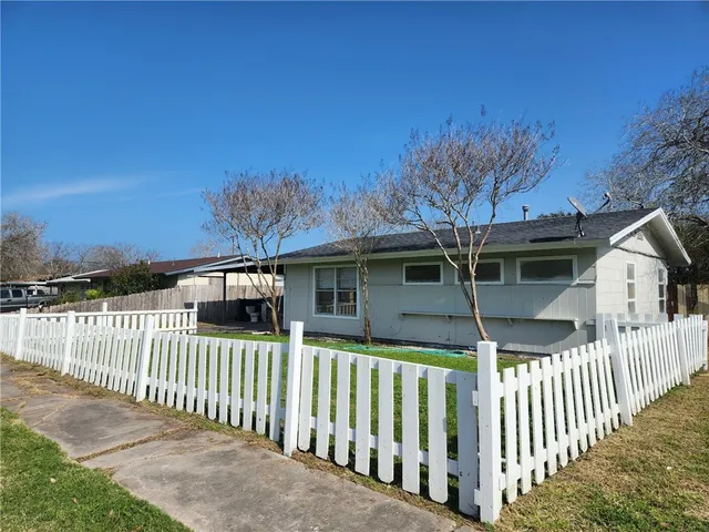 a front view of a house with iron fence