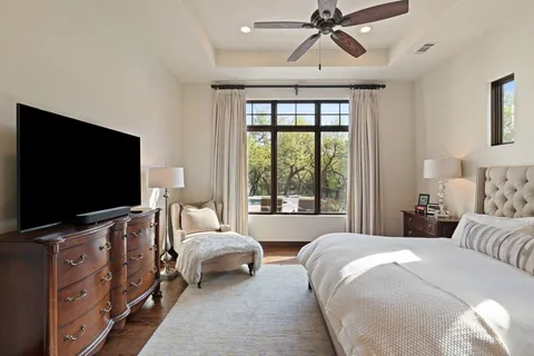 a living room with furniture and floor to ceiling window