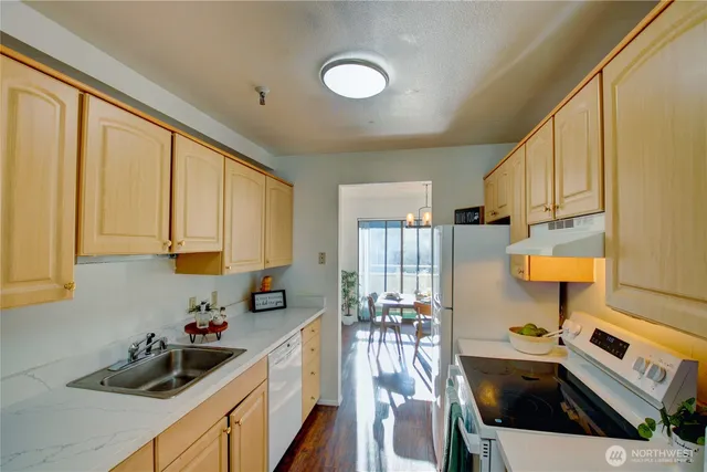 a kitchen with a sink a stove and cabinets