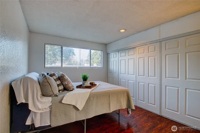 a bed room with a bed and a chair