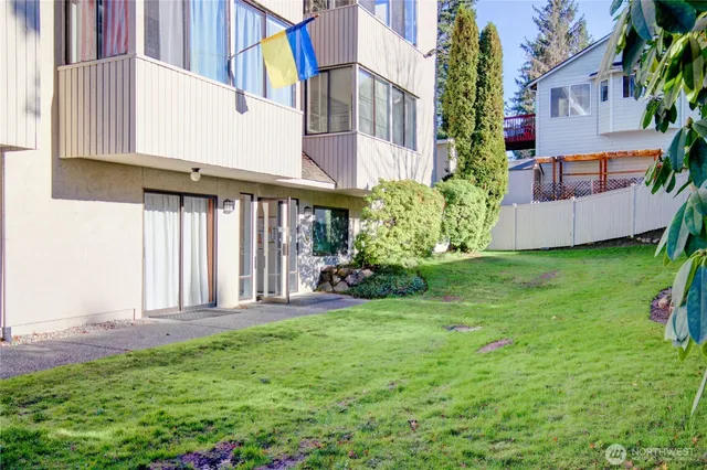 a view of a house with backyard and porch