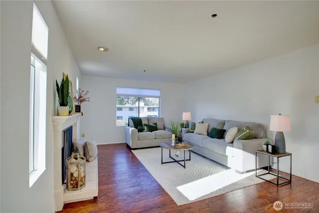 a living room with furniture a fireplace and a flat screen tv