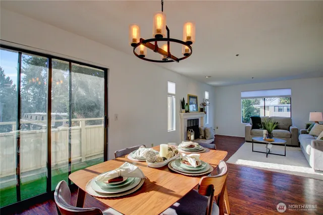 a view of a dining room with furniture wooden floor and chandelier