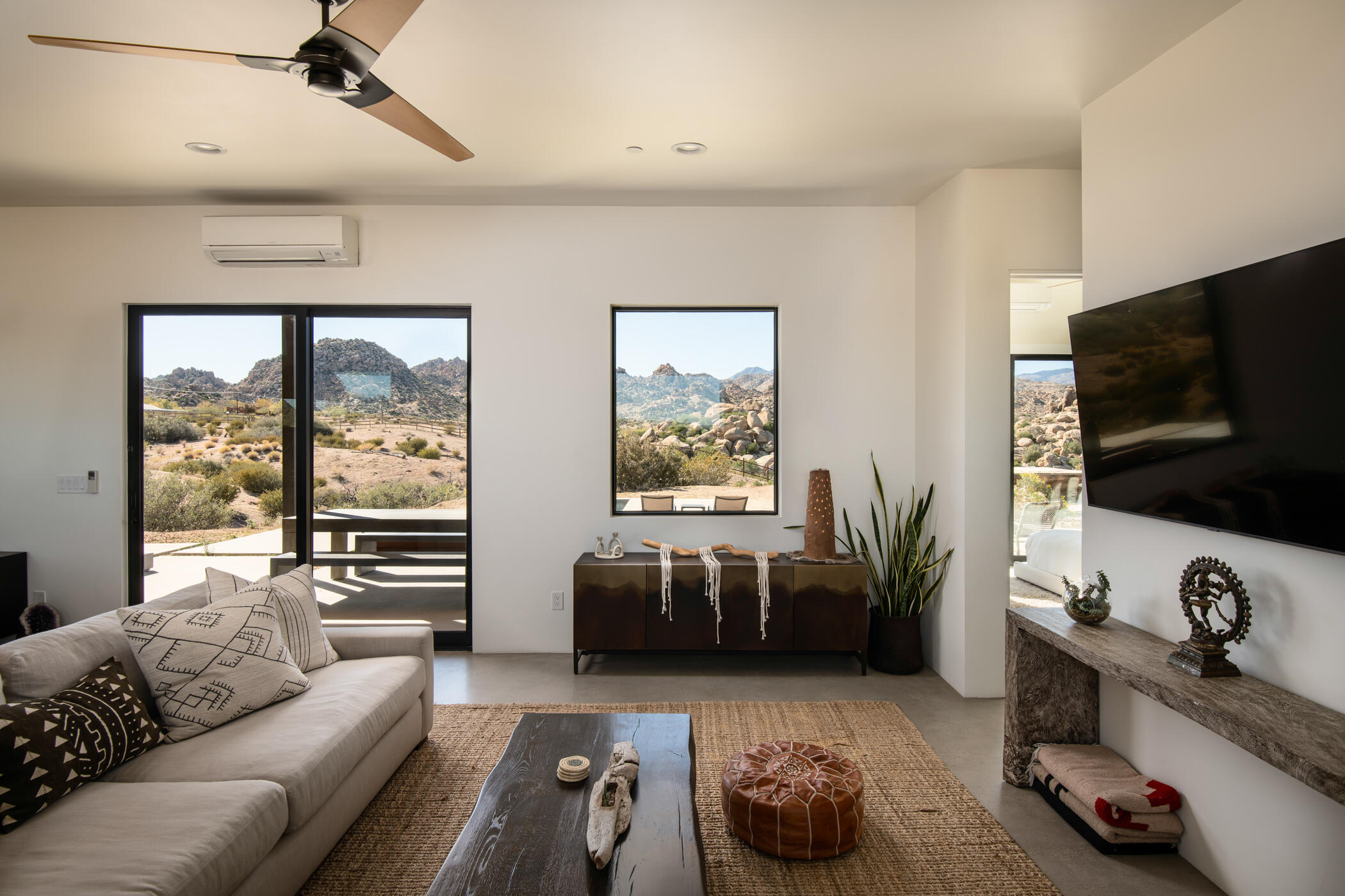 5494 Bronco Road Pioneertown, CA 92268 - Photo 8 of 38 a living room with furniture and a flat screen tv