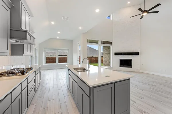 a kitchen with a sink stove and cabinets