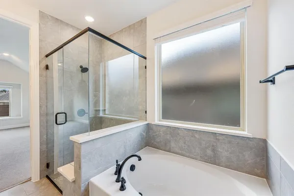 a bathroom with a tub and shower