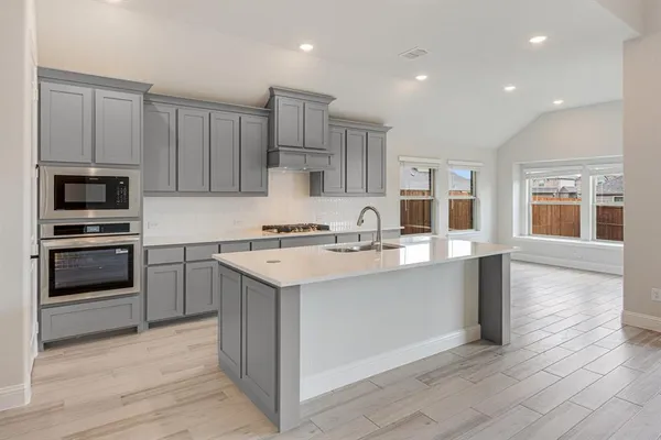 a kitchen with a sink stainless steel appliances and cabinets