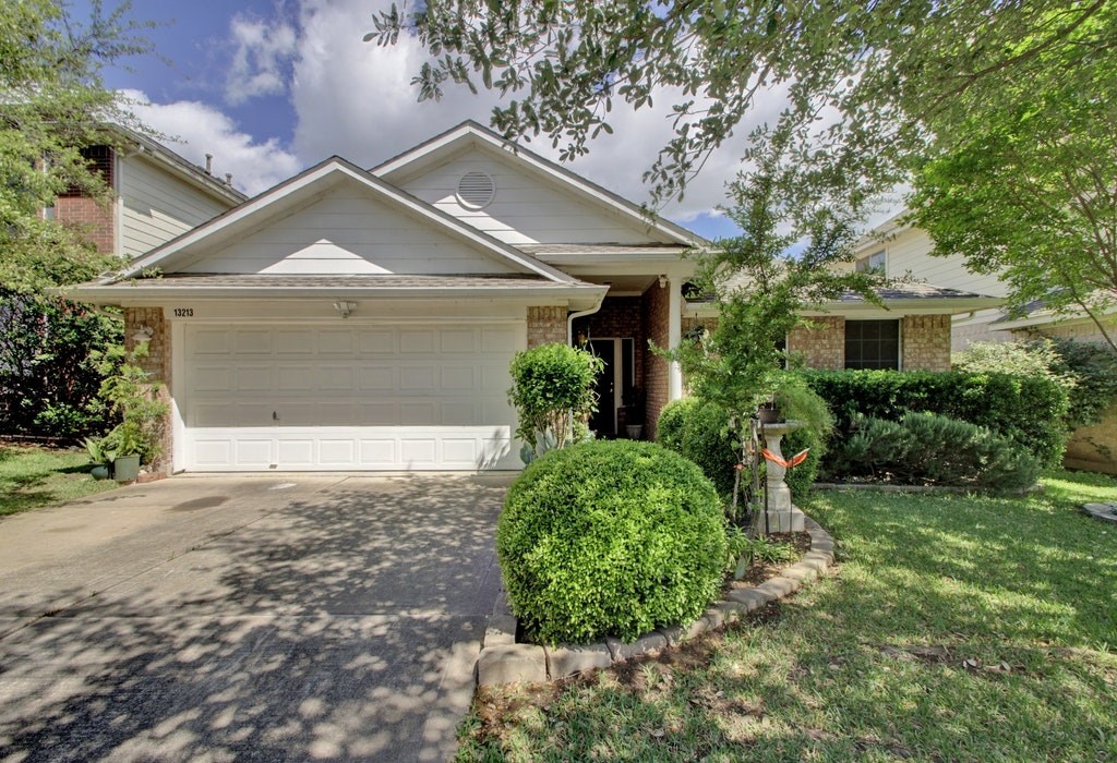 13213 Calf Roping Trail Austin, TX 78727 - Photo 1 of 1 a front view of a house with garden