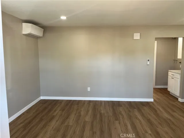 a view of a room with wooden floor and a sink