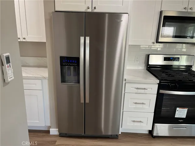 a kitchen with stainless steel appliances a refrigerator and a stove