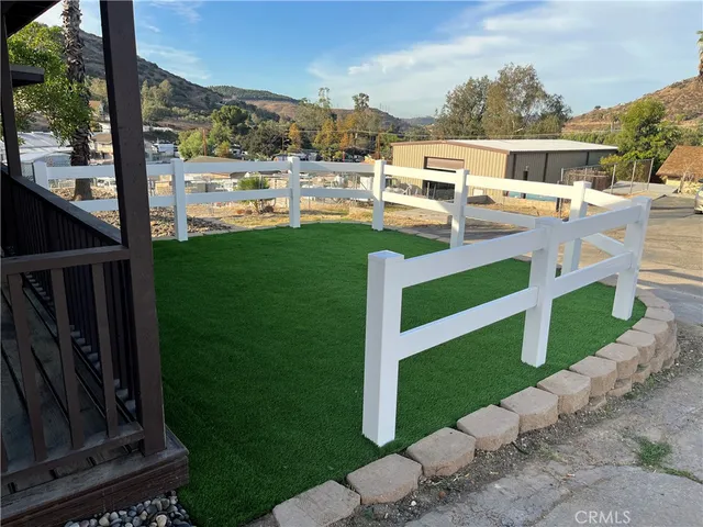 a view of a patio with a table chairs and a yard