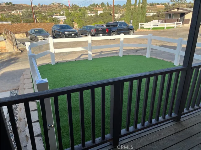 a view of a balcony with yard