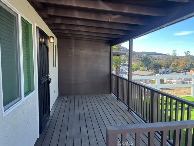 a view of a balcony with wooden floor