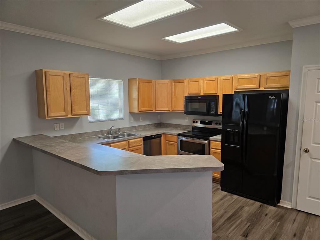7976 48 Way Gainesville, FL 32653 - Photo 6 of 26 a kitchen with granite countertop a refrigerator and a sink