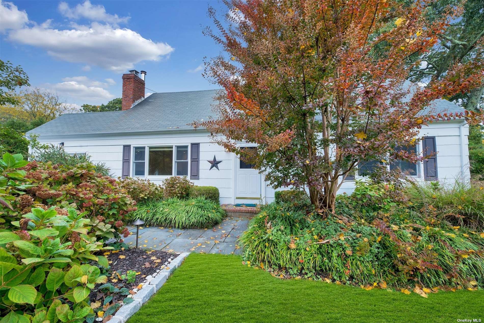 2275 Pine Neck Road Southold, NY 11971 - Photo 1 of 1 a front view of a house with a yard