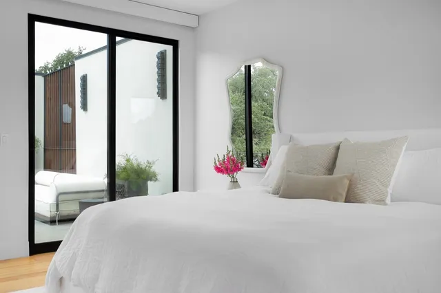 a bedroom with a large bed and a large window