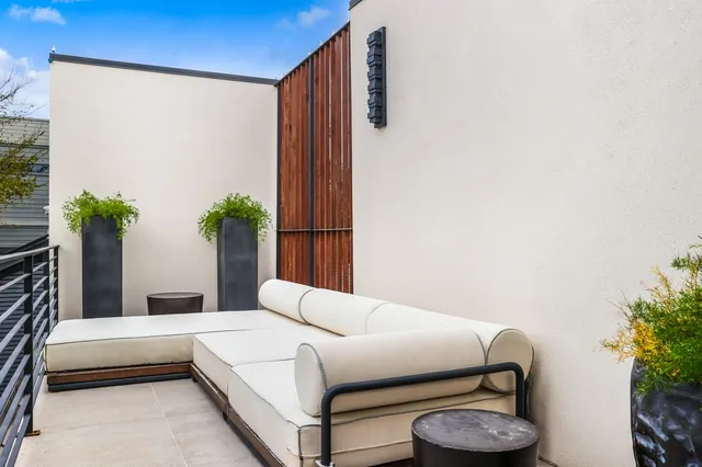 a bedroom with a bed and a potted plant