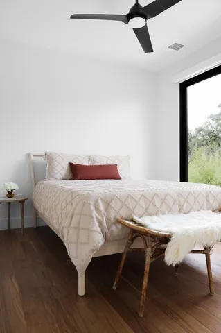 a bedroom with a bed and wooden floor