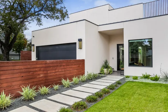 a front view of a house with a garden