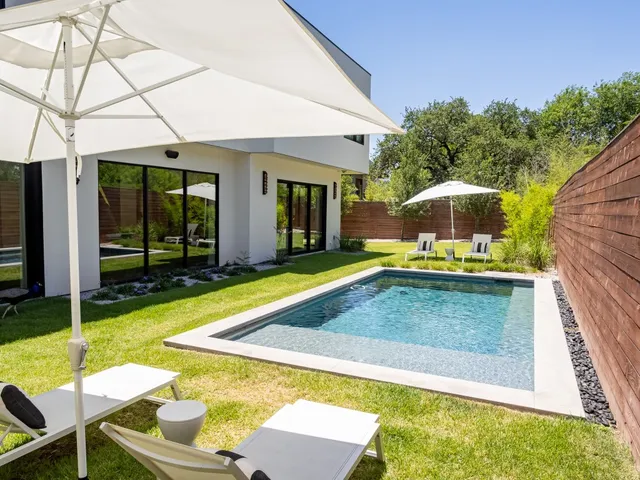 a view of a patio with table and chairs under an umbrella