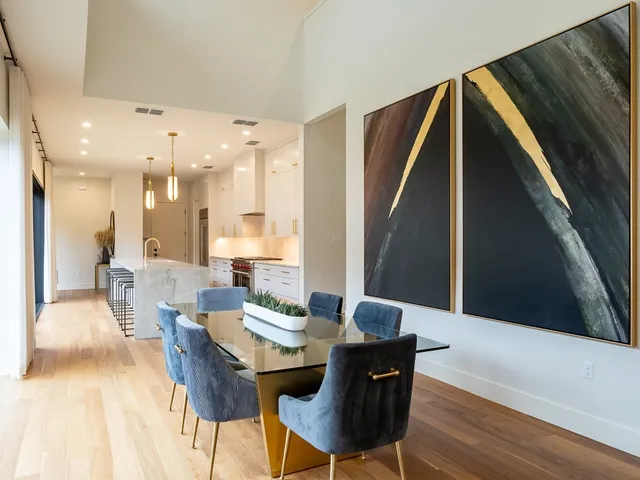 a living room with furniture and a dining table