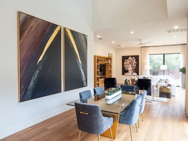 a dining room with furniture window and wooden floor