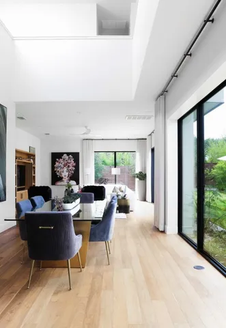 a living room with fireplace furniture and a large window