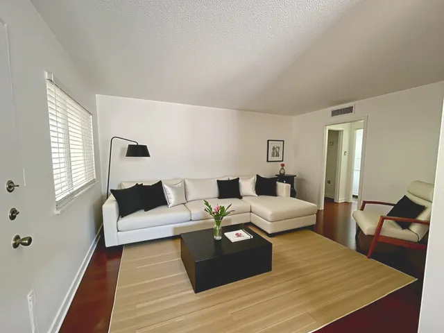 a large bedroom with a bed and wooden floor