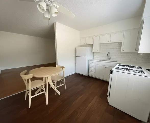 a kitchen with stainless steel appliances a stove a sink dishwasher and a refrigerator
