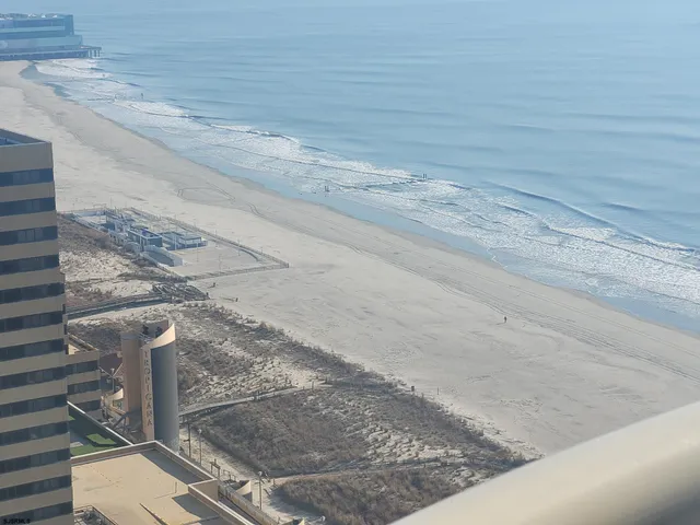 a bathroom with a granite countertop sink a mirror and a shower