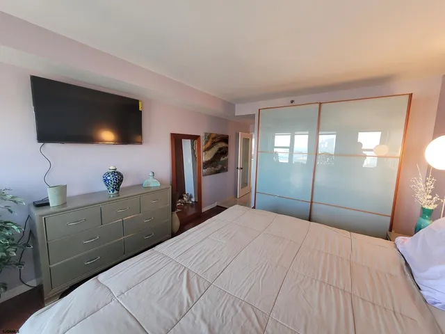 a view of a dining room with furniture and potted plant