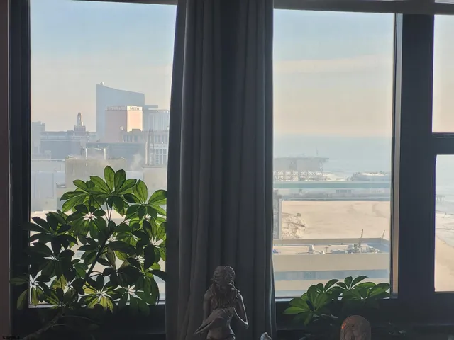 a living room with furniture and a floor to ceiling window