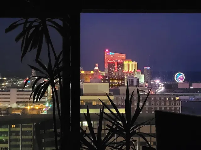 a living room with furniture and view of kitchen