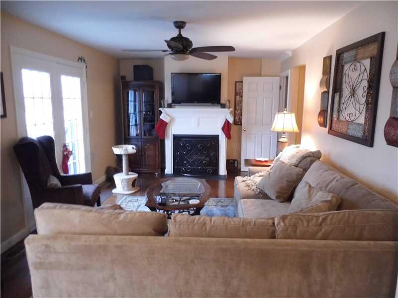 251 Randy Lane Coraopolis, PA 15108 - Photo 9 of 18 Family Room. French doors lead to partysized deck, gas fireplace, ceiling fan and hardwood flooring - open and spacious innto kitchen- great for entertaining and/or every day enjoyment.