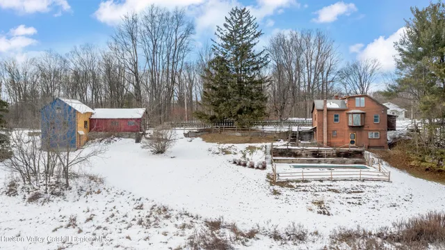 a view of house with snow on the road
