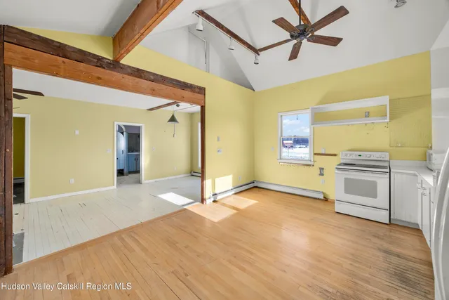 a view of a kitchen with a stove cabinets and wooden floor