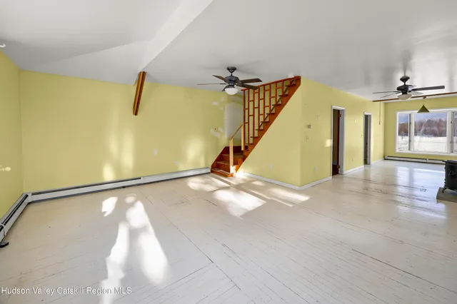 a view of a room with wooden floor