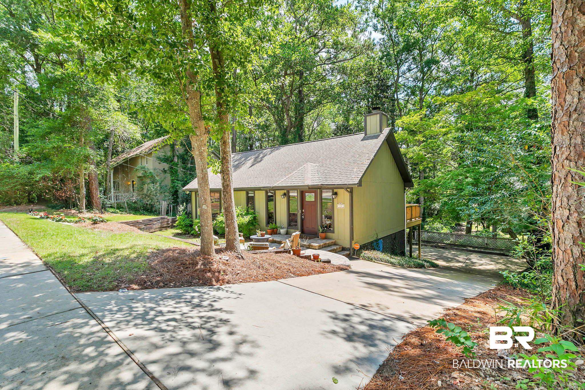 332 Ridgewood Drive Daphne, AL 36526 - Photo 2 of 48 View of front of home with a shingled roof, a chimney, concrete driveway, and covered porch