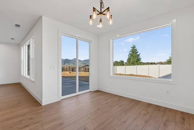 a large kitchen with granite countertop a sink a counter top space stainless steel appliances and cabinets