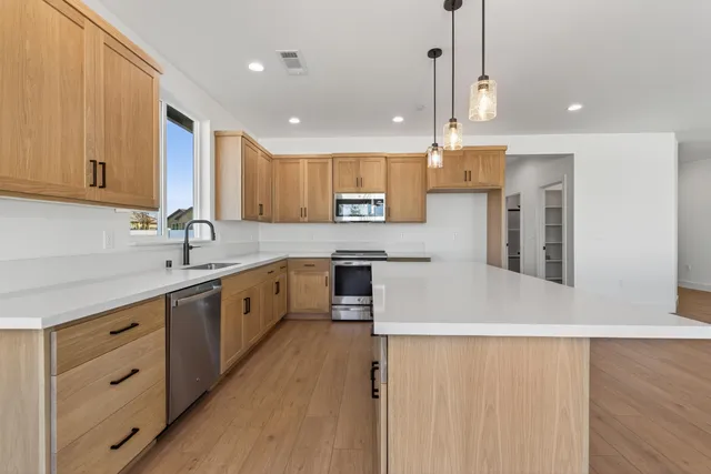 a kitchen with a stove a sink and a refrigerator