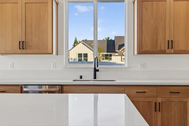 a kitchen with granite countertop a stove a microwave and cabinets