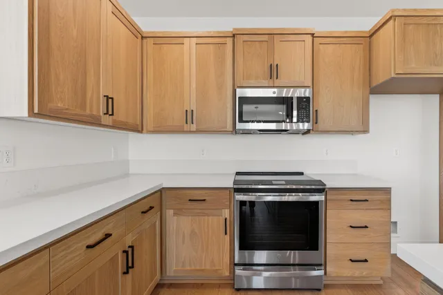 a view of a hallway with wooden floor and a cabinet