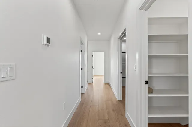 a view of walk in closet with empty racks