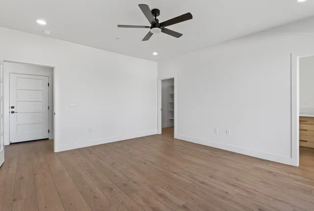 a view of a hallway with wooden floor