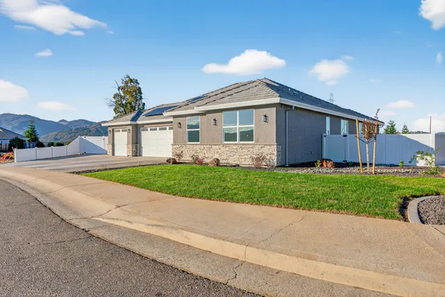 a front view of house with yard and green space