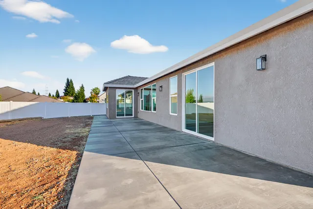 a view of a house with a backyard and a garage