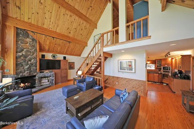a living room with furniture flat screen tv and a fireplace